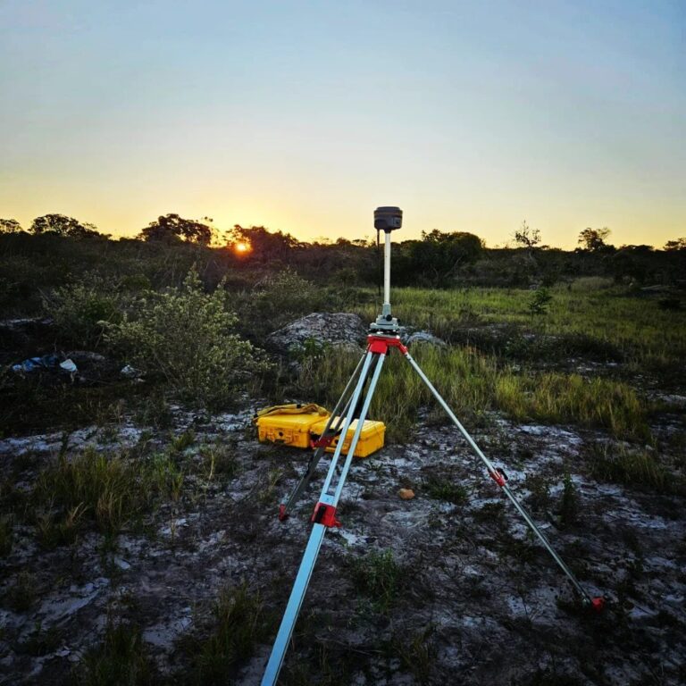 Base de GPS montada em tripé no fim da tarde