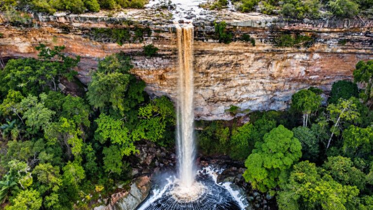 Vista aérea da Cachoeira do Ventura cercada de mata verde, com a água caindo num poço