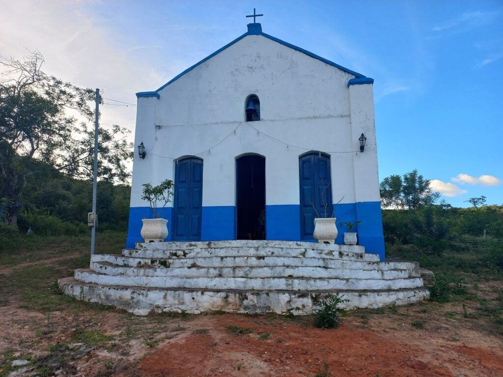 Igreja branca e azul da Vila do Ventura, em Morro do Chapéu, no alto de uma escadaria de pedra caiada
